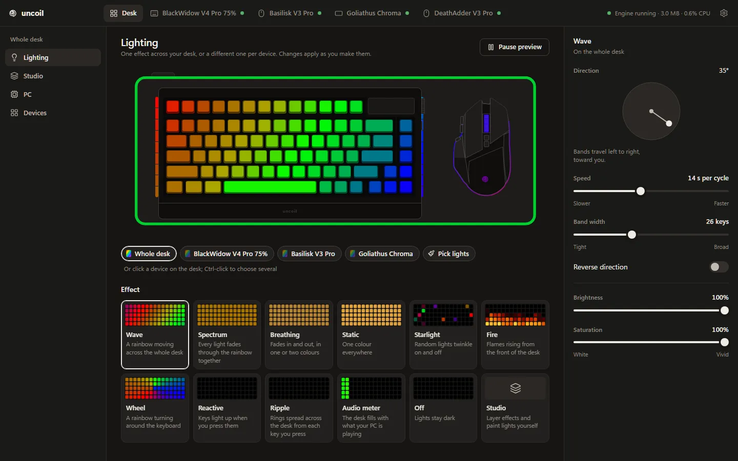 The uncoil desktop app’s Lighting screen: the desk drawn to scale and lit with the wave, cards for every effect from Wave to Off plus Studio, and the wave’s direction, speed, band width, reverse, brightness and saturation controls.